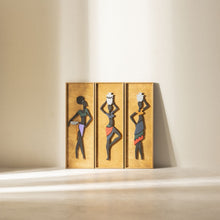 Load image into Gallery viewer, A set of three wooden wall hangings featuring handcrafted natural wood with painted figures of women in different poses.